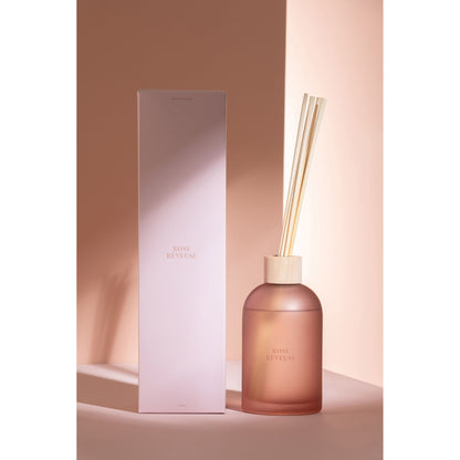 Geurstokjes Accords Essentiels Rose Rêveuse 550ml van J-Line met bijpassende doos in een sfeervolle roze setting